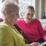 live in care client and carer planning their day