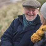 male and female client outside in hat and scarf